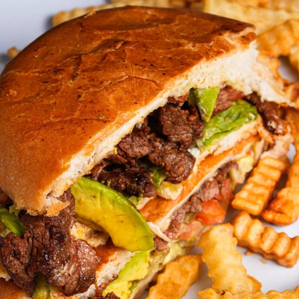 El Mezcal Mexican Restaurant's torta with steak, avocado, lettuce, and tomato, served with crinkle-cut fries.